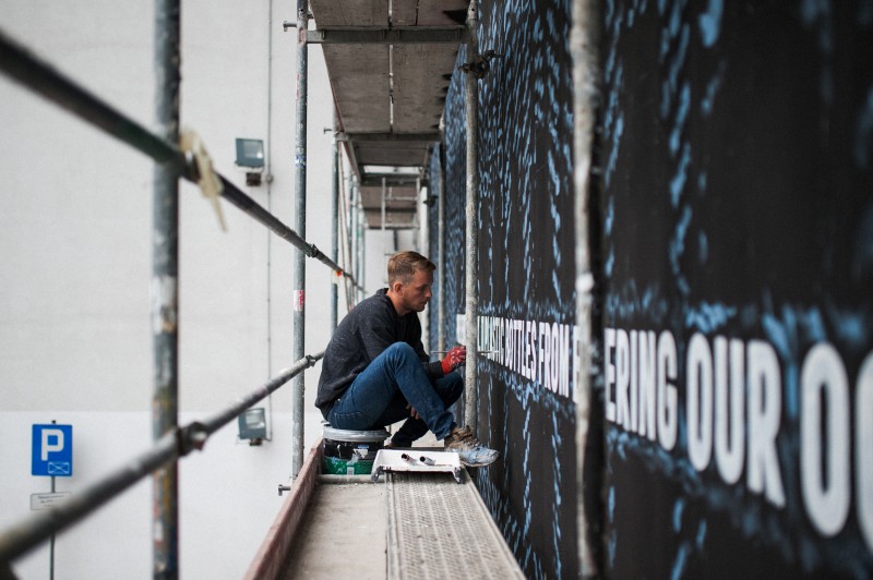 Painter painting mural for Adidas Warsaw | Adidas Parley | Portfolio