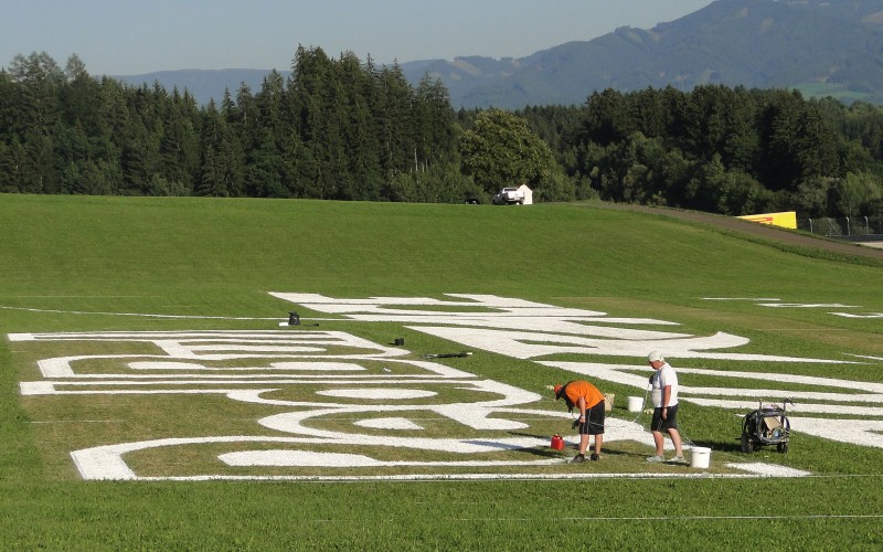 Painting of large Red Bull Air Race logotype at spielberg, Austria | Mural malowany na trawie - RedBull Air Race Austria | Portfolio