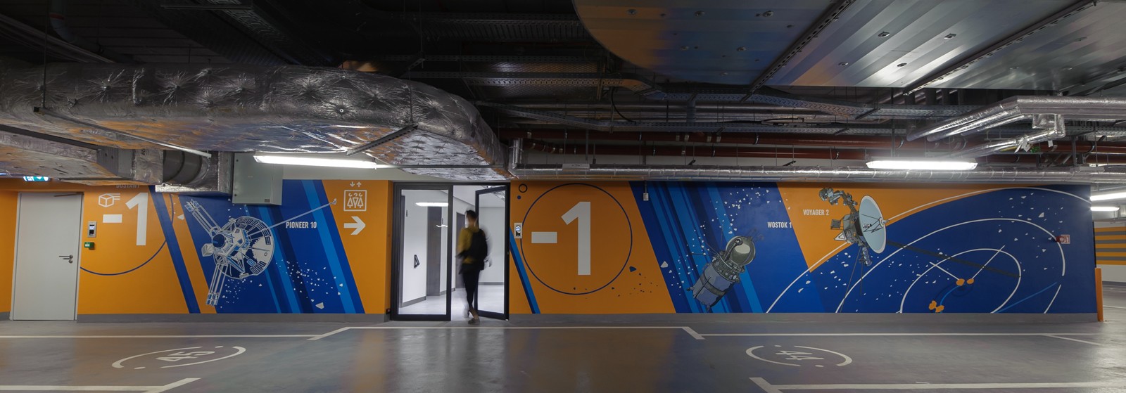Wall design in Proximo office building in Warsaw’s Wola district with a painted Pioneer 10 satellite, a Wostok 1 spaceship, and a Voyager 2 space shuttle | PROXIMO | Portfolio