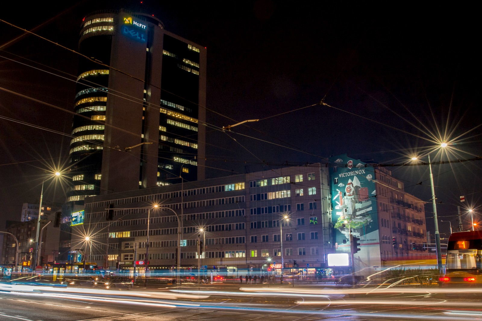 A night view of Plac Zawiszy with a painted advertisement mural for Victorinox | Realizacja murali dla Victorinox  | Portfolio